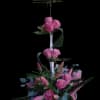 Pink roses and pink lily buds rise in a tall, tiered silhouette