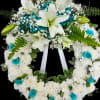 A large standing wreath arranged for sympathy and memorial services, this circular