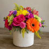 A bright pink rose and a bold orange gerbera daisy take center