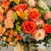 Sunrise-bright roses and lilies combine to make a joyful birthday bouquet or