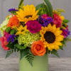 Two bold sunflowers take center stage in this lively flower arrangement, making