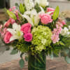 Bright pink roses and trumpet-shaped white lilies create a fresh, romantic statement