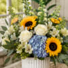 Sunny sunflowers and creamy white roses create an immediate cheerful impression in