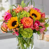 Bright yellow sunflowers and coral-pink roses give this birthday bouquet a sunny