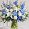 A cool-toned bouquet of blue hydrangeas and white lilies that feels like