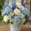 Soft, airy blue hydrangeas take center stage in this blue-and-white arrangement, perfect