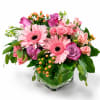 Large pink gerbera daisies take center stage in this pretty-in-pink flower arrangement
