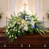 Soft blue delphinium and round blue hydrangeas create a serene horizontal display