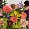 Mixed bouquet with pink roses, purple flowers, and a yellow orchid