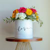 Round box arrangement with pink roses, yellow daisies, and white hydrangeas