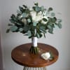 A thoughtfully curated elopement set featuring a bridal bouquet and matching boutonniere