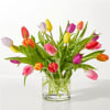 Colorful tulips arranged in a clear glass vase