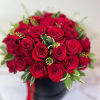 Bouquet of red roses in a black box with a red ribbon