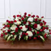 Red roses and white carnations arranged on a casket