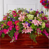 Large mixed floral arrangement with pink lilies, roses, and purple blooms