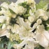 White floral arrangement with lilies and roses