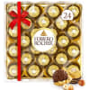 Box of Ferrero Rocher chocolates with a red ribbon