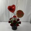 Red roses in a black box with a teddy bear and heart balloon