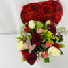 Bouquet of red and white roses with carnations and a Valentine card
