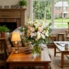 A refined and delicate blend of soft ivory, blush, and peach blooms