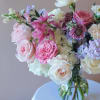 Mixed pink and white flower bouquet in a clear glass vase