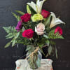 Oriental Lilies, colorful assortment of roses, mums carnations, eucalyptus and greens.
