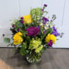 Cylinder vase includes yellow roses, purple mums, stock green hydrangea, alstroemeria, mini