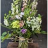A tall, airy garden-style flower arrangement designed to feel hand-picked and fresh