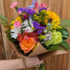 A bright, market-style hand-tied bouquet that feels like sunshine in brown paper-the