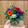 GLASS VASE INCLUDES ORANGE GERBER DAISY, MUM, HYDRANGEA, RED ROSES, HYPERICUM, BELLS