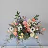 A beautiful vase of premium seasonal blooms that are soft and ethereal.