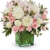 Pink and white roses with alstroemeria in a green glass vase
