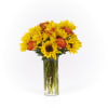 Yellow sunflowers and orange roses in a clear glass vase
