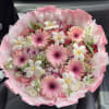 Pink bouquet with gerbera daisies and white flowers wrapped in pink paper