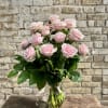 Pink roses arranged in a clear glass vase