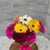 A burst of cheerful color-Gerberas come together in a compact, playful cluster