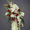 Standing floral spray with red roses, white lilies, and white chrysanthemums