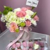 Soft pink and white roses mingle with pillow-like hydrangeas and ruffled carnations