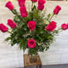 Tall bouquet of hot pink roses in a clear glass vase