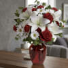 
Perfect for any occasion, this stunning arrangement blends soft white lilies, classic