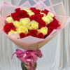 Bouquet of red and pale yellow roses wrapped in pink paper