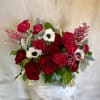 Red and white rose bouquet in a clear vase