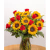 Sunflowers and red roses arranged in a glass vase