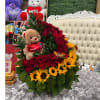 It is a lush arrangement that combines the passion of red roses