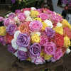 Large bouquet of multicolored roses in pink, purple, white, and yellow