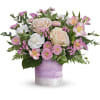 Pink and white mixed flower arrangement in a lavender vase