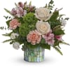 Pink and white floral arrangement in a mosaic glass vase
