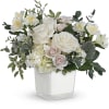 White and blush floral arrangement in a clear square vase