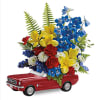 Red toy car topped with a colorful flower arrangement