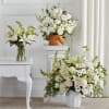 All white arrangements set a calm, elegant tone-perfect as a sympathy arrangement.
